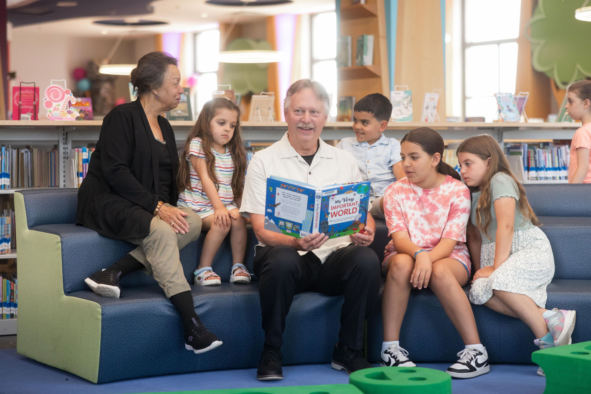A family reads inside the children's room.