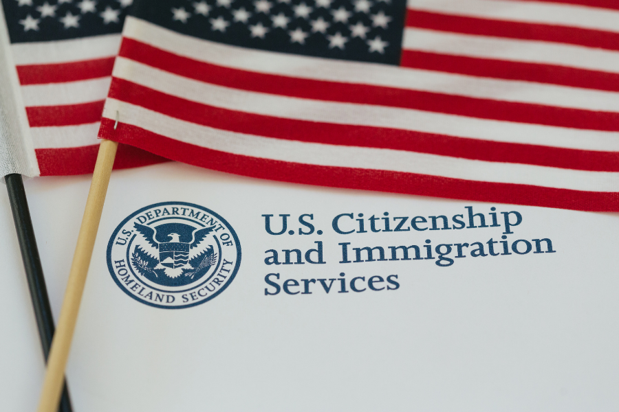 U.S. Citizenship and Immigrations Services paperwork with American flags.