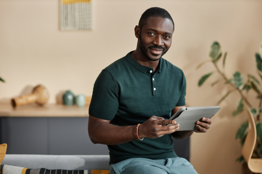 A man works on a tablet, points to Hoopla.