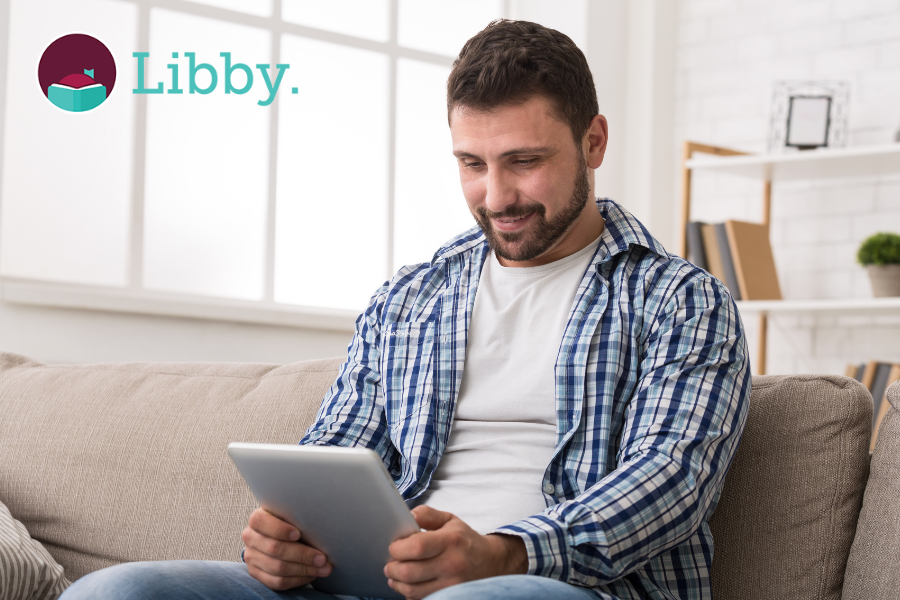 Person reading on a tablet, points to Libby site.