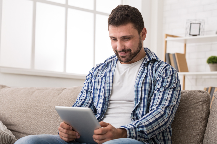 Man reads on a tablet, points to Libby.