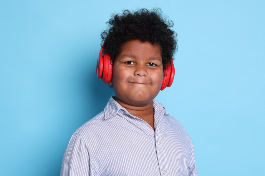 Kid listens on headphones.