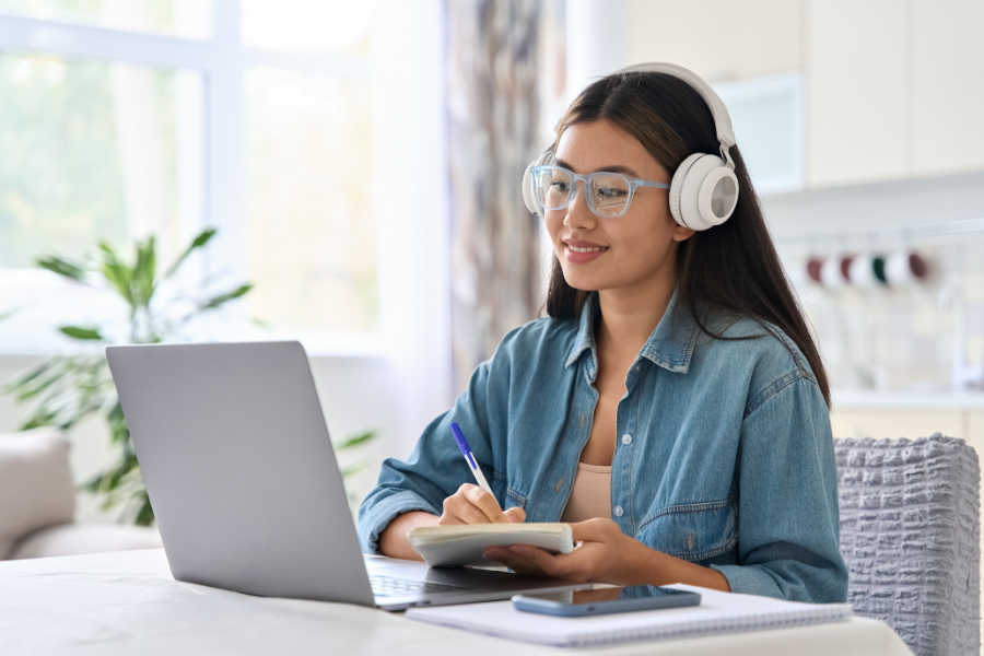 Teen doing work on a laptop.