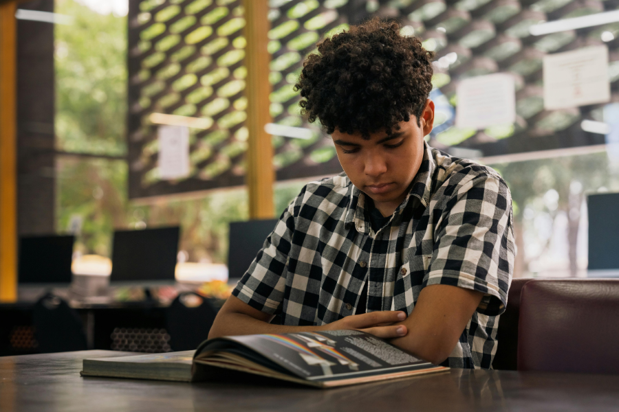 Teen reading a book.