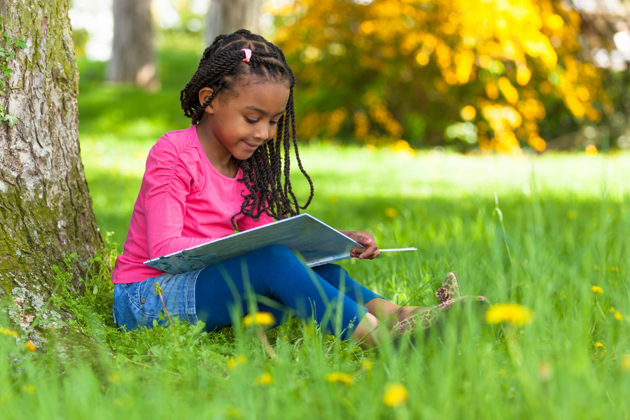 Kid reading a book.
