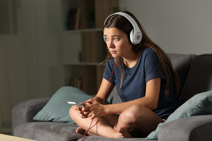 Teen listening on headphones.
