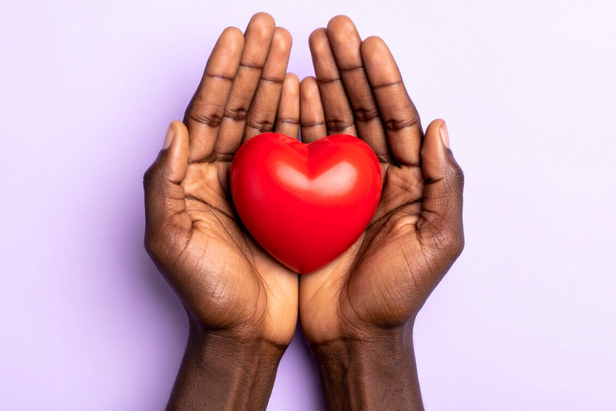 Hands holding a heart, points to social services.